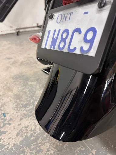 Motorcycle fuel tank after paintless dent repair with original paint preserved