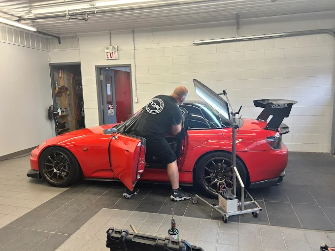 Honda S2000 receiving paintless dent repair from a Precision Dent technician