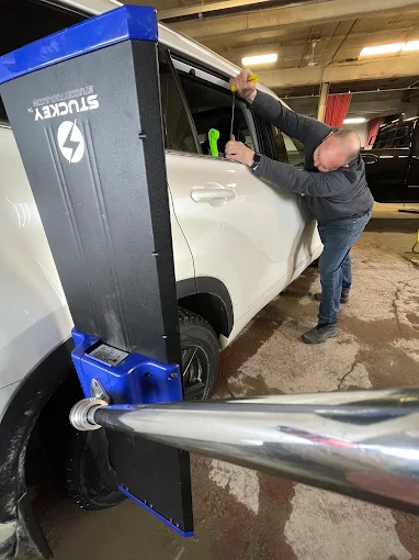 Paintless dent repair technician working a dent for a Mississauga customer