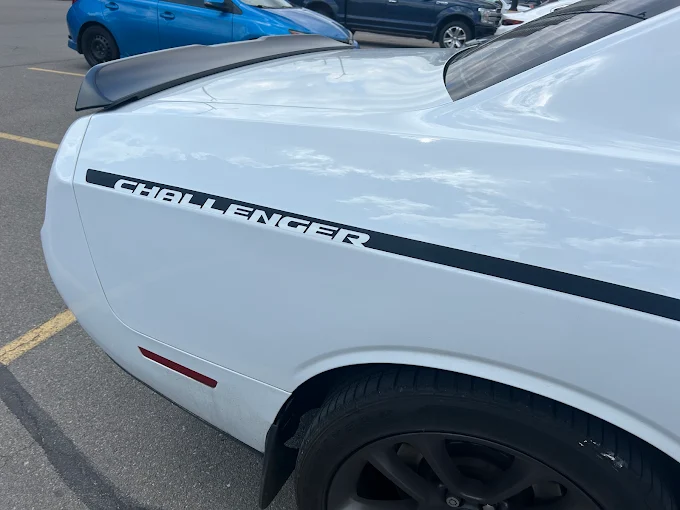 Dodge Challenger panel after paintless dent repair, mirror-smooth factory finish